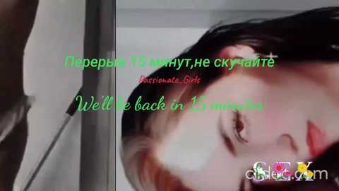 Video of a woman with long black hair, pale skin, and red lipstick, wearing a black top, with text overlay in green and red.