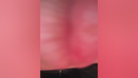 The image is a blurred video of a person's face with pinkish-red skin tones, possibly indicating an inflammatory or allergic reaction. The background and surroundings are indistinct due to the blurriness.