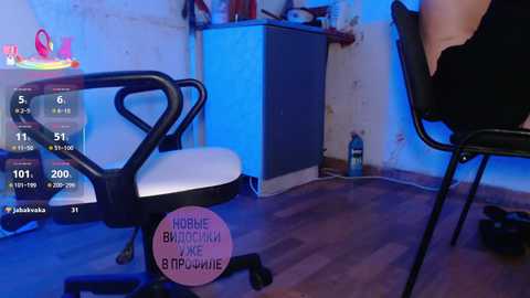 Video of a dimly lit room with a white office chair, a digital display showing weather data, and a pink sign reading \"Hobie Banana Bike.\