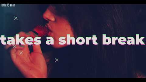 A close-up video of a person with medium-length dark hair, lips parted, holding a red object, likely a microphone, against a dark background. The text overlay reads \"takes a short break\" in bold, colorful letters.