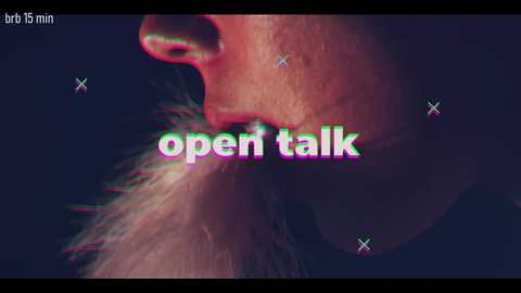 A close-up video of a person's mouth, partially obscured by a fuzzy, light-colored beard. Text overlay reads \"open talk\" in bright, multicolored neon-style letters. The background is dark and grainy, giving a retro, glitchy aesthetic.
