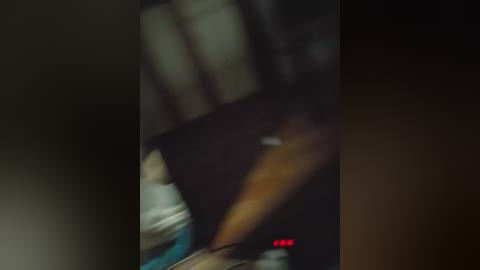 A blurred video captures a person's legs and torso in motion, wearing a white shirt, possibly in a dark, dimly-lit room. The image is out of focus and grainy, with a red \"END\" timestamp at the bottom.