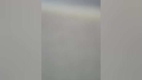 Video of a minimalist, abstract scene featuring soft, blurred light streaming through a vertical slit, creating a serene, monochromatic gradient of whites, grays, and blues. The background is devoid of distinct objects, emphasizing a sense of calm and simplicity.