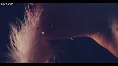 Video of a close-up, dark-haired woman's face, showing her eyes partially closed, with four white crosses indicating specific areas of focus.