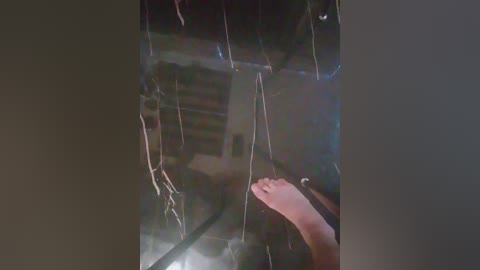 Video of a cracked glass pane with web-like cracks, revealing a person's hand on the inside, indicating a window with a broken seal.