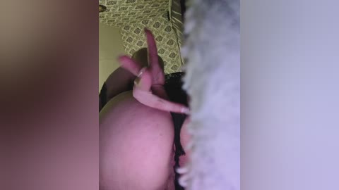 A video of a close-up, explicit scene featuring a person's bare buttocks, pinkish and light skin tone, with a pink dildo inserted. Background shows a patterned wall and blurred edges.