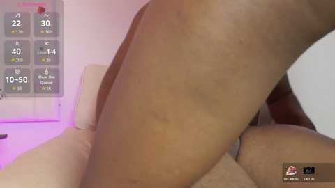 Video of a close-up of a nude, light-skinned person's thigh with a smartphone's virtual weight tracking app display in the background.