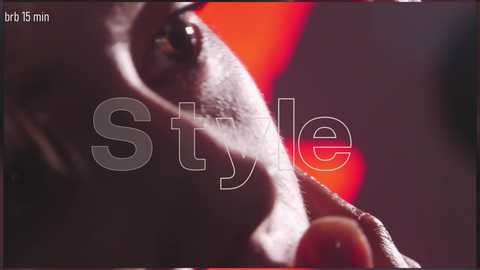 A close-up video of a person's face, showing a stylized, blurred eye and cheek. The background is a gradient of red and black, with the word \"Style\" overlaid in white, centered.