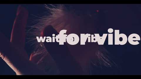 Video of a man with tousled, light-colored hair, making a peace sign, dimly lit. \"wait4vibe\" text overlays in white.