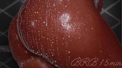 A close-up video of a wet, dark-skinned person's buttocks, covered in water droplets, with the text \"BBR 5min\" in the bottom right corner.