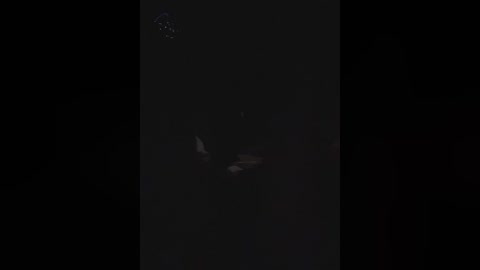 A video of a dark, star-filled night sky with a faint, blurry image of a person or object in the center, possibly a celestial body or distant light source.