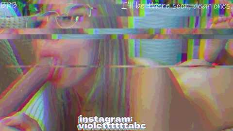 A glitchy, pixelated image of a woman with long, light brown hair and glasses, her mouth partially open, with text overlay: \"I'll be under sobriety ones,\" \"instagram: violettttttbae.\