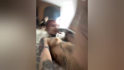 A blurry, grainy video of a naked woman with tattoos, possibly Asian, licking a man's finger in a dimly lit room.