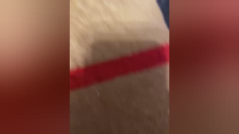 A blurred, close-up video shows a person's hand with a red bandage on the thumb, suggesting a recent injury or medical procedure. The background is indistinct and out of focus, emphasizing the hand.