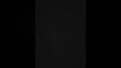 A digital video featuring a black, rectangular shape centered in the frame, with minimal contrast and no discernible details, creating a stark, minimalist aesthetic.