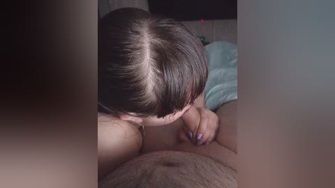A video depicting a close-up of a woman with straight, dark hair performing oral sex on a man, whose hairy abdomen is partially visible.