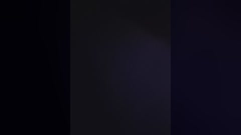 Video featuring a dark, vertical gradient from black to deep purple, with no discernible objects or people, creating a moody, abstract visual effect.