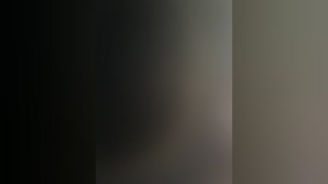 Video of a minimalist, abstract wall with a smooth, gradient transition from dark gray to light gray, creating a subtle, monochromatic ambiance.