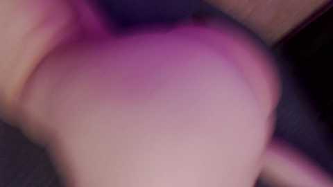 A close-up video of a woman's bare buttocks, showing a light skin tone and a hint of pinkish hue, with blurred background.