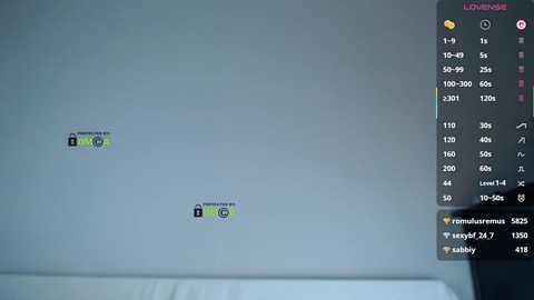 Video of a wall with two green stickers, \"Aurora\" logo, and \"Polaris\" logo, in a dimly lit room with a window. A Twitch chat window with \"Polaris\" and \"Polaris\" chat messages in the background.