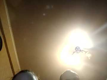 Video of a bright sun through a window, partially obscured by a person's head, showing a close-up of the sky, window frame, and ceiling.