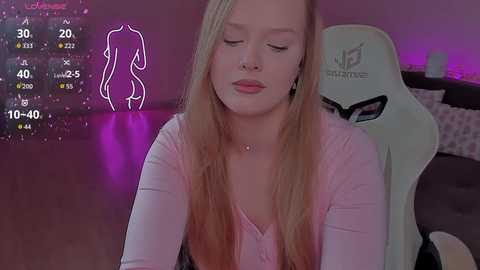 Video of a young woman with long blonde hair, closed eyes, and a serene expression, sitting in a white gaming chair in a dimly lit room with purple ambient lighting.