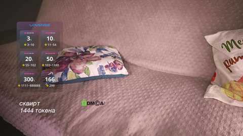 Video of a white pillow with colorful floral pattern, overlaid with a virtual reality interface showing health metrics, including heart rate and blood oxygen levels.