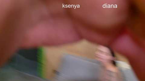 Blurry video of a woman's torso, likely Diana, with visible skin tone and breast outline, wearing a green top.