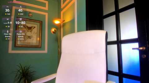 A video of a modern office with a teal wall, framed butterfly artwork, a white ergonomic chair, a floor lamp, and frosted glass doors.