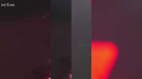 A dimly lit video of a dark, blurry scene, with a faint red glow on the right and a text overlay reading \"btr 15 min.\