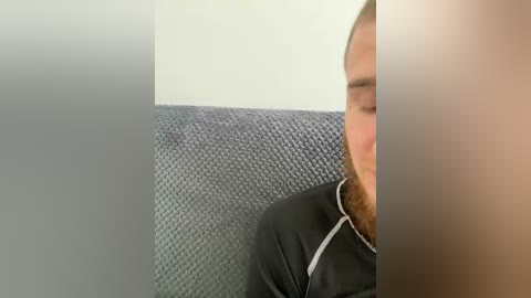 Video of a person with light skin, brown beard, wearing a black jacket, sleeping on a textured, grey fabric seat. The image is divided into three sections: left, middle, and right.