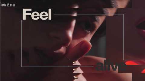 A close-up video of a young Asian man with short black hair, wearing a black shirt, licking his finger with a serious expression. The background is blurred, with text overlaying \"Feel\" and \"Alive.\