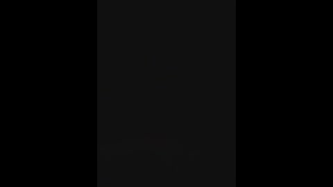 This image is a video of a black rectangle with a slight gradient from dark at the top to lighter at the bottom. The background is completely black, making the rectangle stand out prominently.