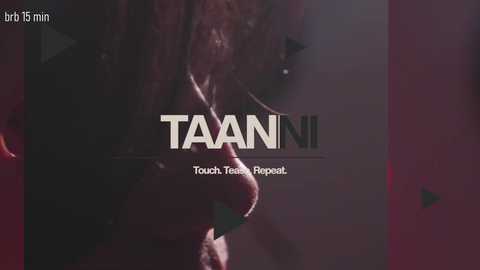 Video of a dimly lit, close-up side view of a woman with long brown hair, wearing a black top, partially obscured by shadows. Text overlays: \"TAANI\" and \"Touch The Reboot.\