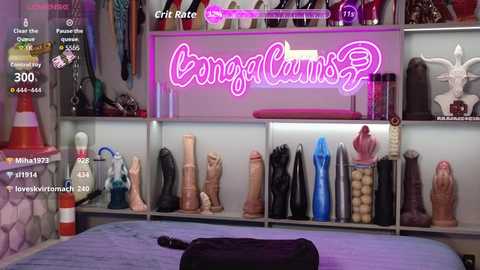 A video of a bedroom with a neon \"Vingercums\" sign, a bed, and a variety of realistic, lifelike dildos and sex toys displayed on shelves, with digital overlays showing streaming metrics.