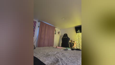 A video of a dimly lit bedroom with a Star Wars Darth Vader action figure, a gaming chair, and a TV with a yellow screen, adorned with gaming-related posters.