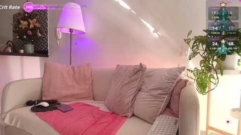 Video of a cozy living room with a beige sofa, pink throw blanket, green plant, white lamp, and purple wall lights.