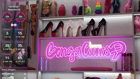 Video of a vibrant, well-lit room with a neon \"Bongacams\" sign, displaying various sex toys, including dildos and vibrators. The background features shelves with colorful sex toys, adding a playful, erotic ambiance.