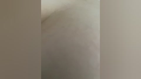 A video of a white wall with a slight, subtle shadow, creating a minimalist and abstract visual effect. The texture is smooth, with no visible cracks or imperfections. The image focuses on the contrast between light and shadow.