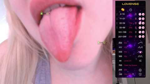 Close-up video of a young woman with fair skin and long blonde hair, tongue extended and pink tongue visible. Overlay shows a \"LoveSense\" app with stats and icons.