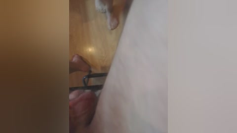 Video of a close-up of a person's hand holding a metal rod, with blurred background. The hand appears to be gripping the rod tightly, suggesting tension or effort. The image is dimly lit, creating a moody, intimate atmosphere.