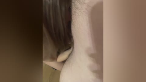 A close-up video showing a person's face with fair skin and dark hair, focusing on the nose and mouth, with blurry background.