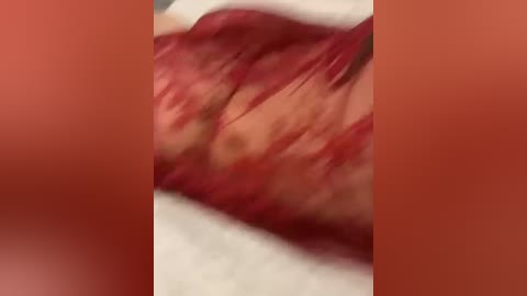 Video of a close-up of a person's thigh with prominent red hair, partially obscured by blurred background.