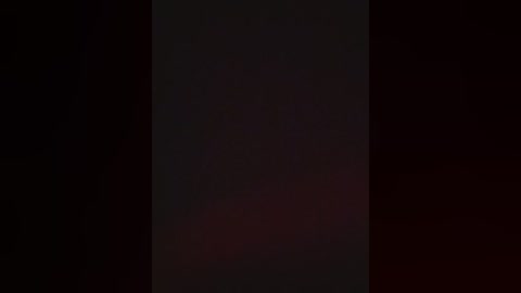 A video with a dark, blurry background, featuring a vertical black rectangle in the center, possibly a shadow or a simple graphic element. The image is monochromatic with no discernible details, evoking a minimalist or abstract aesthetic.