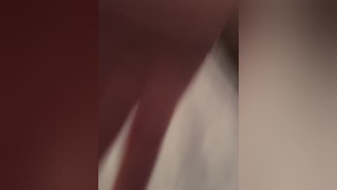 A blurred, abstract video featuring a close-up of a person's face with skin tones ranging from light beige to deep red, creating a soft, dreamy effect.