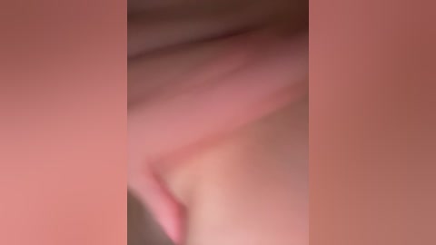 A close-up video of a human vulva with fair skin, showing natural texture and folds, with the surrounding skin blurred. The image is soft-focused, emphasizing the intimate nature of the subject.