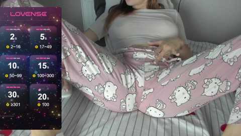 Video of a woman in pajamas with a baby on a bed, showing a love meter screen on the left.