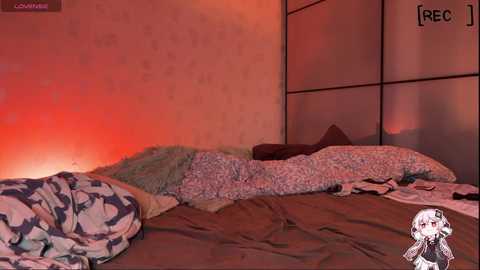A video of a messy, dimly lit bedroom with a red-orange glow, featuring a bed with disheveled bedding, pillows, and a TV on the right. The room has a Japanese-style wall.