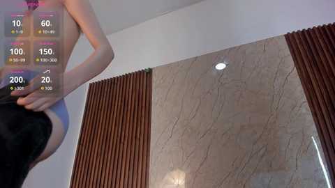 Video of a person in black underwear, standing in a room with beige marble walls and vertical wooden blinds. Overlay shows fitness stats: 10 reps, 60 kg weight, 150 height, 100 calories, 20 minutes.