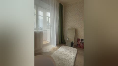 Video of a dimly lit, vintage-style bedroom with beige wallpaper, floral pattern, and a white fluffy rug. A green curtain and a large mirror lean against the wall.